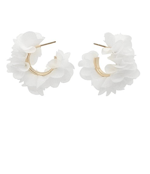 Pair of white ruffled hoop earrings on a white background