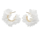 Pair of white ruffled hoop earrings on a white background