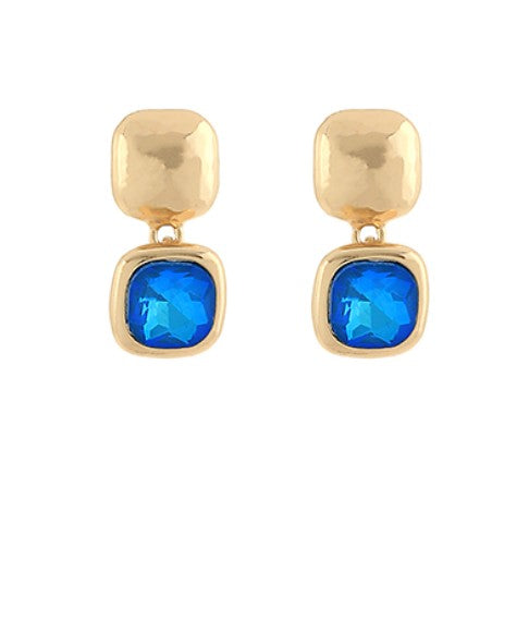 Gold earrings with royal blue gemstones on a white background