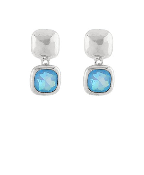Silver earrings with blue gemstones on a white background