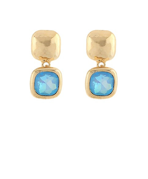 Gold earrings with light blue gemstones on a white background