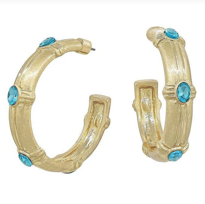 Gold hoop earrings with turquoise stones on a white background