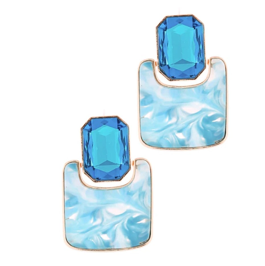 Blue gemstone earrings with marble-like design on a white background