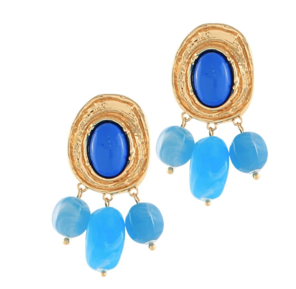 Gold-framed earrings with blue stones on a white background
