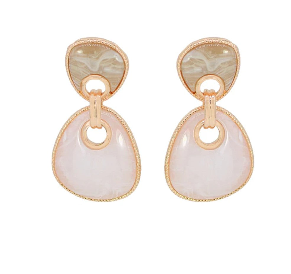 Pair of earrings with gold and beige stones on a white background