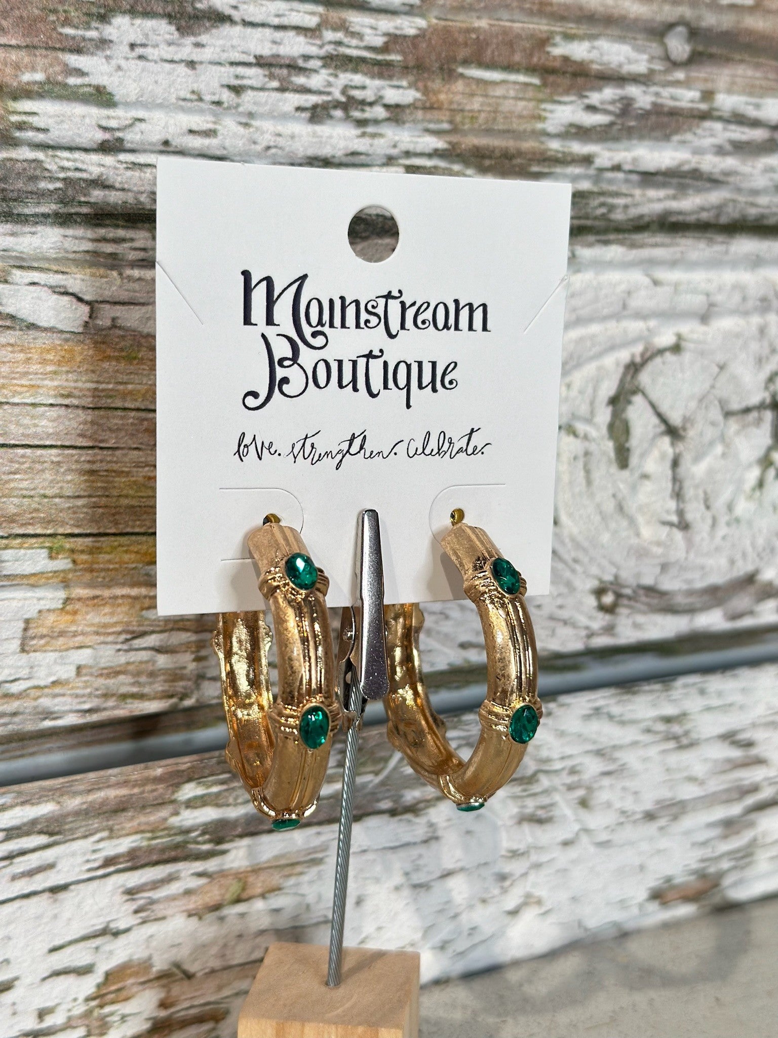 Gold hoop earrings with green gemstones 