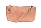 Pink leather clutch bag with a strap on a white background