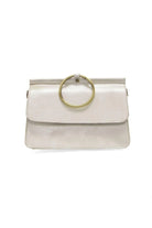 White handbag with a gold ring handle on a white background
