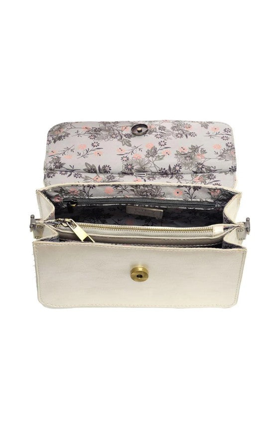 Floral-patterned clutch bag with a white exterior on a white background