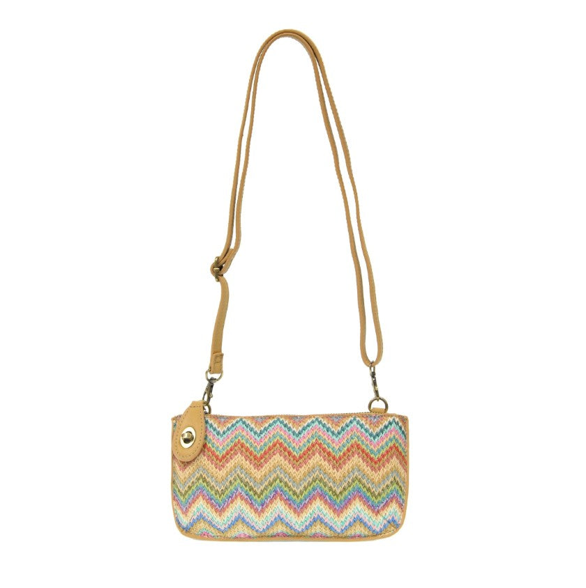 Multicolored zigzag patterned handbag with a strap on a white background