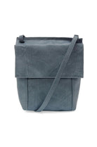 Blue leather crossbody bag on a white background