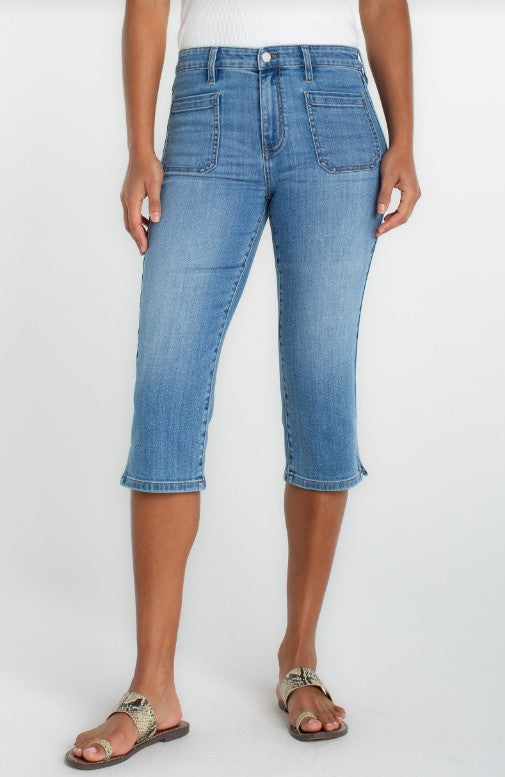 Person wearing capri blue jeans 