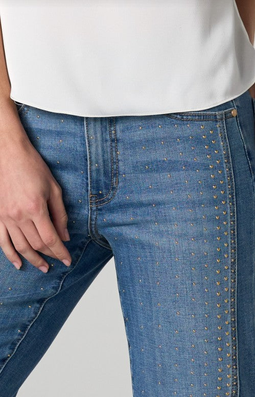 Close-up of blue jeans with gold studs 