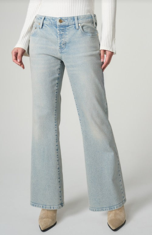Light blue jeans worn by a person on a plain background