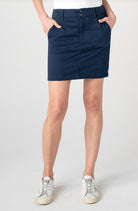 Person wearing a navy skort with white background.