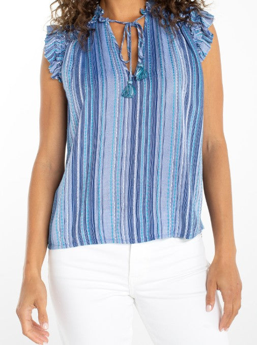 Woman wearing a blue striped sleeveless top with tassel details 