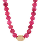 Necklace with pink beads and a gold clasp on a white background
