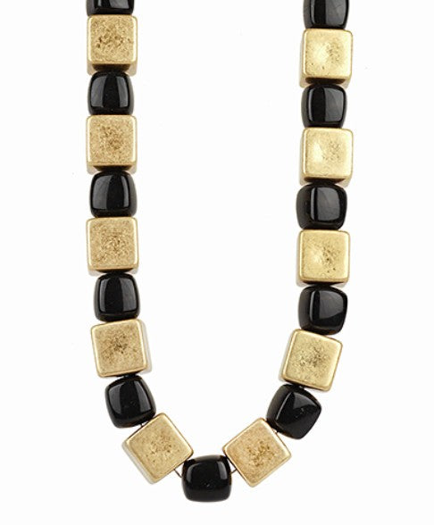 Necklace with gold and black square beads on a white background