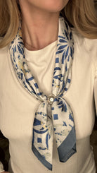 Silky royal blue abstract pearl magnetic scarf with soft geometric patterns and elegant pearl clasp detail.
