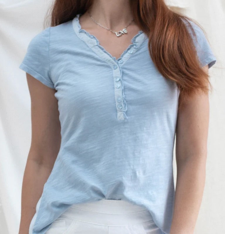 Light blue short-sleeve shirt worn by a person on a white background