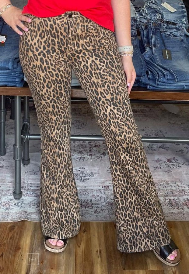 Person wearing leopard print pants in a store setting