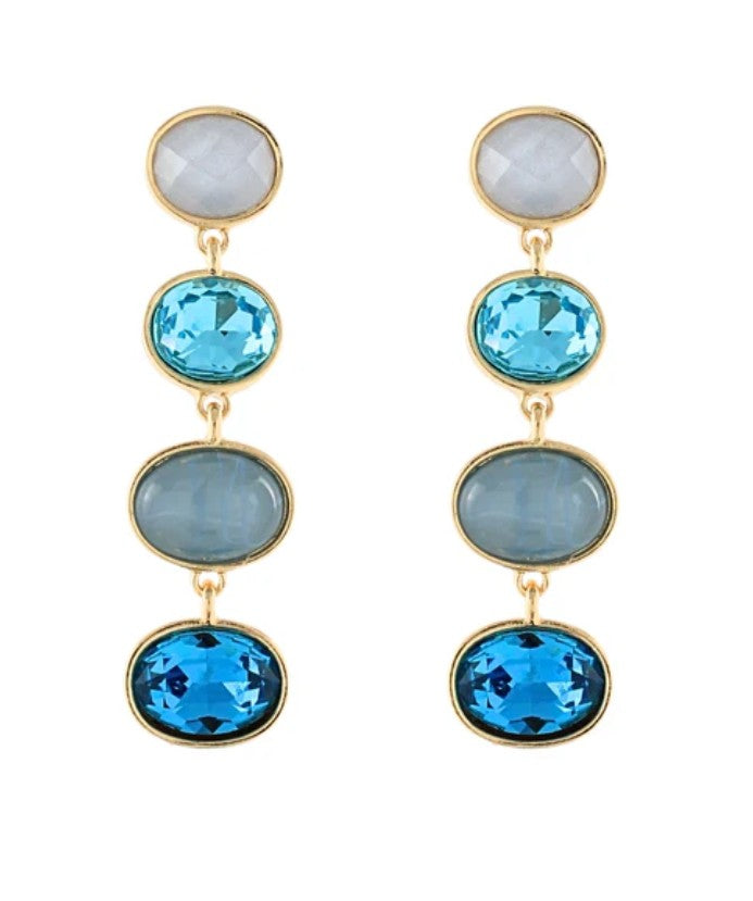 Gold earrings with blue and gray gemstones on a white background