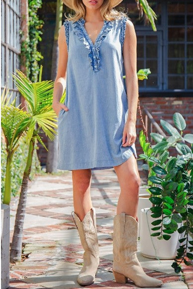 Woman wearing a denim dress and beige cowboy boots 