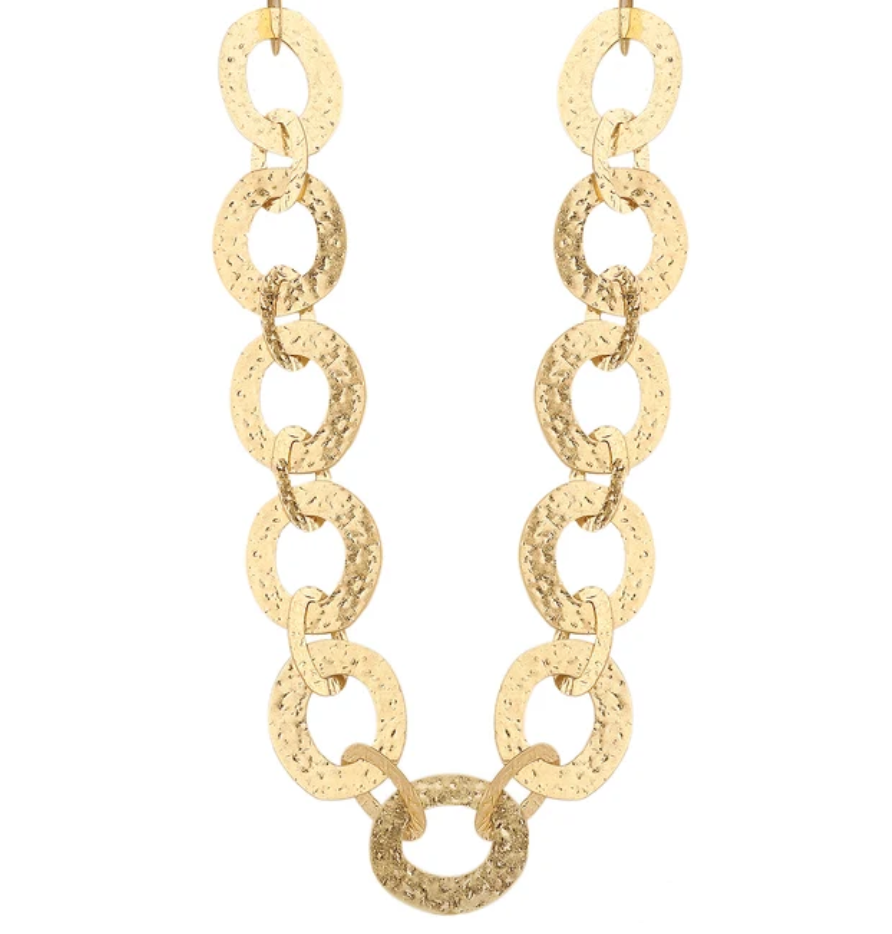 A gold chain necklace featuring large, textured oval links, displayed against a solid white background.