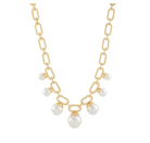 A gold chain necklace featuring elongated oval links and several dangling white pearl beads arranged in a V-shape at the center, shown against a plain white background.
