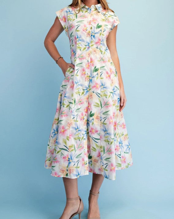 Woman wearing a sleeveless floral midi dress with a button-front design, collared neckline, soft watercolor floral print, fitted waist, and flowy A-line silhouette.