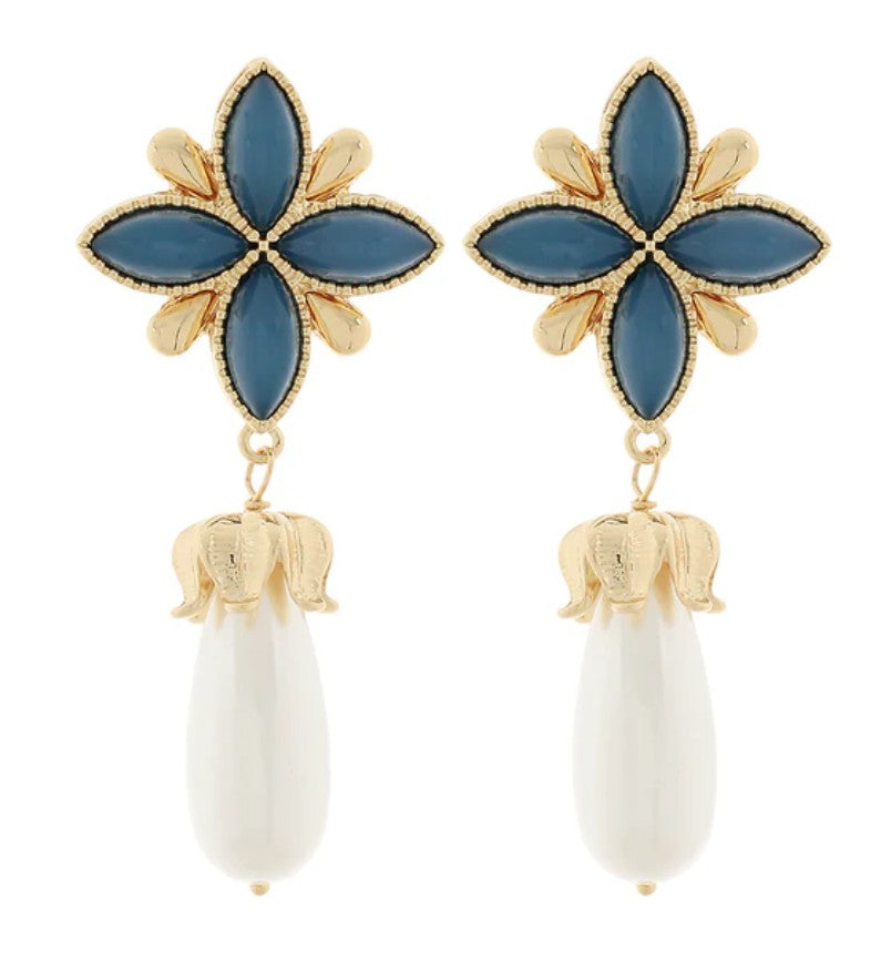Earrings with blue flower-like tops and white teardrop-shaped bottoms on a white background