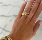 Chansutt Pearls gold ring on a hand with a marble background