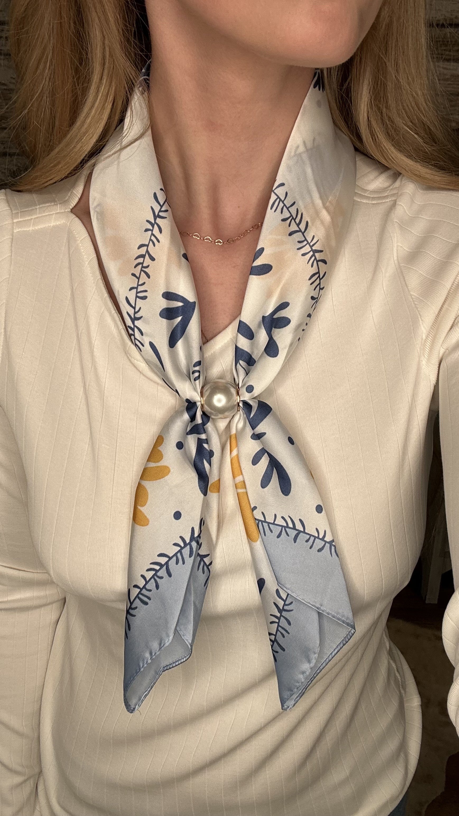 Silky blue and gold botanical pearl magnetic scarf with soft satin fabric and pearl clasp accent.