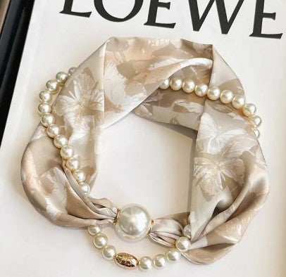 Necklace with pearls and a floral-patterned scarf