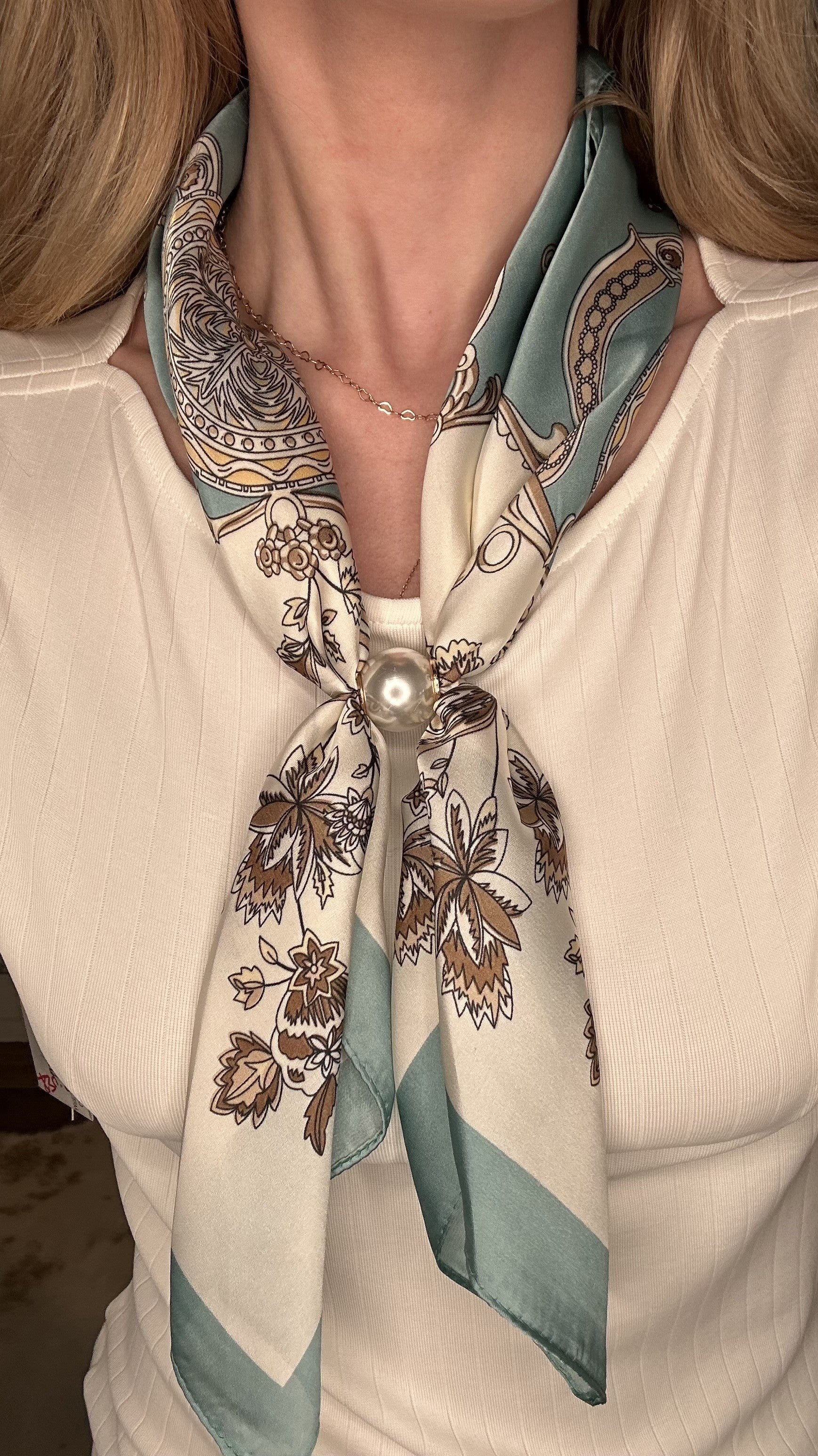 Silky teal and cream pearl magnetic scarf featuring ornate botanical prints with a satin finish and pearl clasp accent.